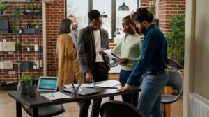 diverse group coworkers planning research analysis business office working startup partnership create project report with charts data statistics using documents digital tablet 1 Smart4Ethiopia